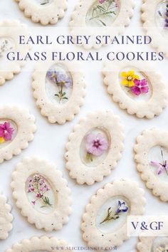 some cookies with flowers on them and the words, ear grey stained glass floral cookies