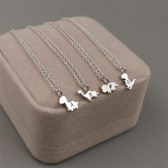 Introducing our Small Dinosaur Pendant Necklace, a whimsical and charming accessory for dinosaur enthusiasts and nature lovers alike. Handcrafted with sterling silver, this necklace features a collection of delightful dinosaur pendants that will transport you back to the prehistoric era. With four iconic dinosaur designs to choose from, including the mighty T Rex, the majestic Triceratops, the graceful Plesiosaur, and the towering Brachiosaurus, you can select the perfect combination to create y Silver Animal Design Jewelry For Gifts, Silver Jewelry With Animal Design For Gift, Animal Design Jewelry Gift, Dino Necklace, Dinosaur Jewelry, Dinosaur Pendant, Dinosaur Necklace, Dinosaur Gifts, Dinosaur Design