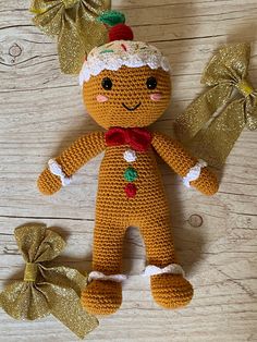 a crocheted ginger doll next to two bows