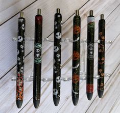 five pens with halloween designs on them are lined up