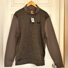 a brown and gray shirt hanging on a door with a tag attached to it's collar