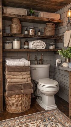 a bathroom with lots of towels and baskets on the shelves next to the toilet is shown