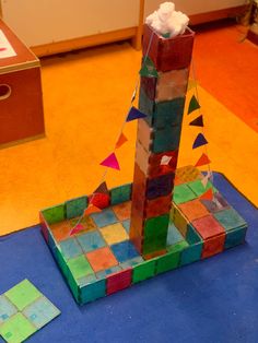 a sculpture made out of colored blocks on the floor