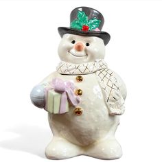 a snowman figurine holding a gift box