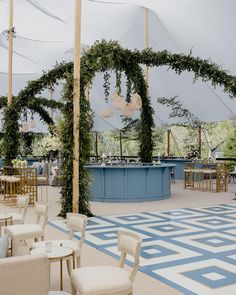 the inside of a tent with tables and chairs set up for an outdoor wedding reception