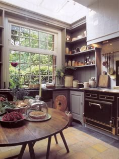 a kitchen filled with lots of wooden furniture