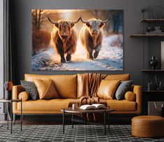 two long haired cows walking in the snow on a canvas wall hanging above a couch