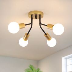 a ceiling light with five lights on it in a living room or dining room area