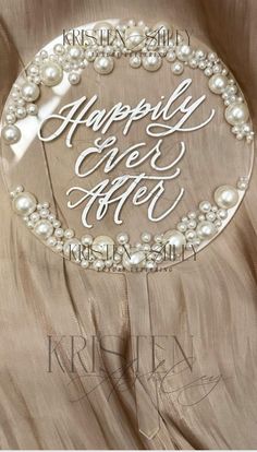 a sign that says happily ever after with pearls on the bottom and an oval frame around it