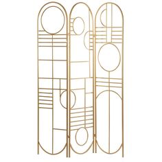 three tall gold metal racks with circles on them