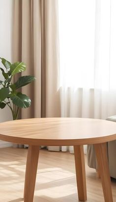 a wooden table in front of a window with curtains on the side and a potted plant next to it