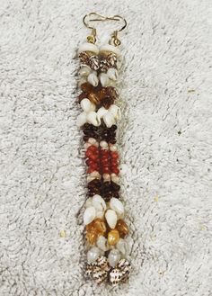 Stunning Niihau earrings with an amazing array of rare colors that really POP.... Brown Beaded Shell-shaped Jewelry, Brown Beaded Shell Jewelry, Bohemian Multicolor Shell-shaped Jewelry, Bohemian Brown Shell-shaped Jewelry, Bohemian Brown Shell Jewelry, Niihau Shells, Rare Colors, Puka Shell, Ear Hook