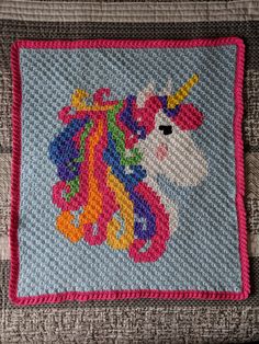 a close up of a rug with a unicorn on it