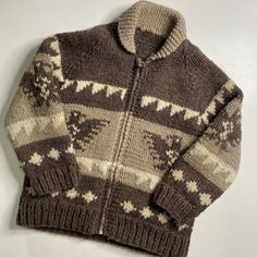 a brown and white sweater sitting on top of a table