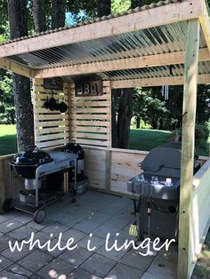 an outdoor bbq area with grills and barbecueing equipment on the patio under a pergolated roof