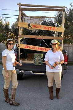 two women standing next to each other in front of a truck