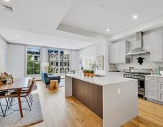 an open kitchen and dining room with hardwood floors