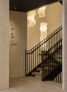 an empty room with stairs and chandeliers hanging from the ceiling