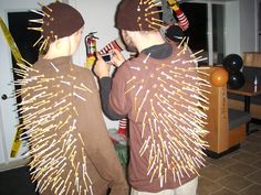 two young boys dressed in costumes made to look like they are holding bottles and fireworks