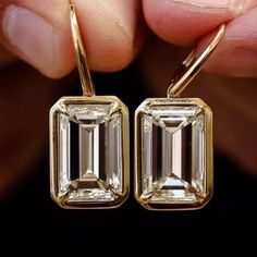 Dangle Drop Earrings Gift, 12x8MM Emerald Brilliant Cut Moissanite Wedding Earrings, Bezel Set In 14k Yellow Gold Latch Back Bridal Earrings ✹✹𝐖𝐞𝐥𝐜𝐨𝐦𝐞 𝐭𝐨 𝐂𝐫𝐚𝐳𝐲𝐃𝐢𝐚𝐦𝐨𝐧𝐝𝐬𝐂𝐨✹✹ Detail about stones Moissanite & Simulated Stone: ----------------------------- Stone Shape: Emerald Cut Stone Size: 12x8 mm Weight: 10.68 TCW Color: Colorless Cut: Excellent Clarity: VVS ★ 𝑰𝒕𝒆𝒎 𝑫𝒆𝒕𝒂𝒊𝒍𝒔:- ☛ Metal Purity: Solid Gold (10KT, 14KT, 18KT); Silver(925 Sterling, 935 Argentium), 950 Luxury Emerald Cut Cubic Zirconia Earrings, Luxury Emerald Cut Earrings For Women, Luxury Emerald Cut Diamond Earrings For Wedding, Luxury Modern Emerald Cut Diamond Earrings, Luxury Emerald Cut Earrings For Wedding, Luxury Jewelry With Bezel Setting Drop Earrings, Luxury Emerald Cut Earrings With Prong Setting, Luxury Emerald Cut Diamond Earrings, Bridal Stone Earrings