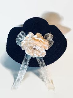 "A beautiful cream satin flower with beads & a cream lace ribbon embellish this black wide brim hat.  A perfect accessories for weddings, church or the Kentucky Derby.  It is a once size fits most.   Measures 17\" across." Elegant Beach Hats With Handmade Flowers, Elegant Flower Mini Hats For The Beach, Elegant Flower Mini Hats For Beach, Black Wide Brim Hat, Ladies Dress Hats, Spring Hat, Spring Hats, Dress Hat, Satin Flowers