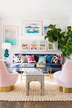 a living room filled with furniture and pictures on the wall above it's coffee table