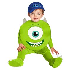 a little boy in a green costume with big eyes