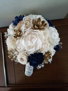 a bridal bouquet with white and blue flowers