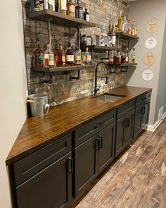 an image of a kitchen counter top that is made out of wood and has shelves on the wall