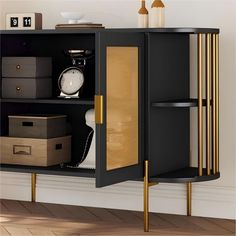 a black cabinet with gold trim and shelves in the corner next to a white wall