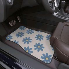 a car floor mat with blue flowers on it