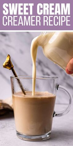 a person pouring cream into a glass mug