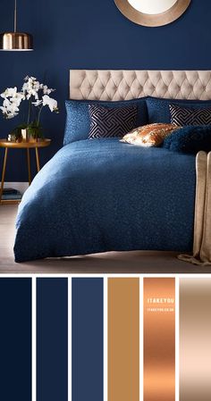 a bedroom with blue walls and gold accents