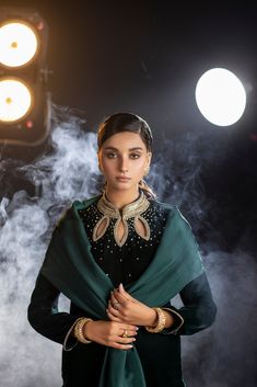 An emerald green velvet outfit with a cut-out embroidered neckline and sparkling embroidered trousers (included) is a striking and glamorous choice that combines rich color, intricate detailing, and a touch of sparkle.  Complete this ethereal look with this luxurious silk dupatta (sold separately) with sparkling sequin