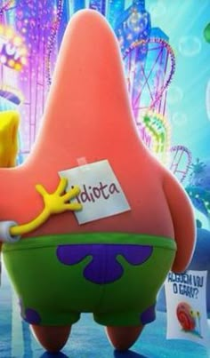 the spongebob character is holding a sign in front of an amusement park background