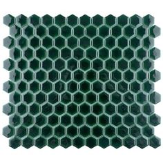 green hexagonal tiles are stacked together on top of each other, forming an interesting pattern