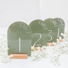 three green table numbers sitting next to each other