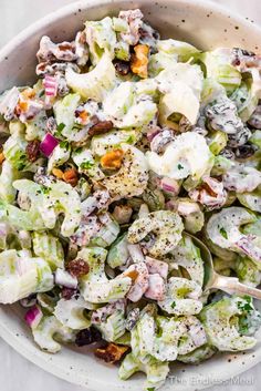 a white bowl filled with salad on top of a table