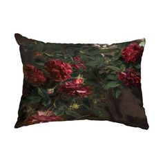 a decorative pillow with red flowers on it