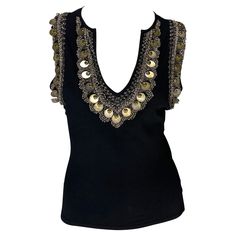 Presenting a fabulous black brass embroidered Versace sleeveless top, designed by Donatella Versace. From the Spring/Summer 2004 collection, this top features a deep v-neckline and is made complete with brassy embroidery, beads, and discs around the collar and arm holes. Add this elevated top to your wardrobe! Approximate measurements: Size - IT42/US8 22" shoulder to hem 36" - 42" bust 27" - 35" waist 9.5" shoulder to neckline plunge 83% rayon, 17% spandex Versace Donatella, Archive Pieces, Versace Top, 00s Style, Embroidery Beads, Digital Closet, Sleeveless Top Designs, Embroidery Top, Cute Lazy Outfits