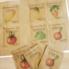 four vegetable seed packets are sitting on a table