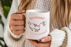 a woman holding a coffee mug with the words serrotin? in this economy