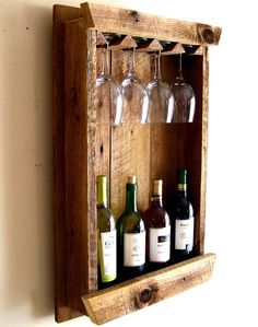 wine glasses and bottles are sitting on a wooden shelf