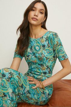 Detailed with a timeless paisley print, this midi dress is designed in a figure-skimming fit with a round neckline and short sleeves. Elevated with a unique twist at the back to create an open-back detailing. Dress up or down for every invite. Model wears a size 10. Cheap Flowy Paisley Print Dress, Affordable Paisley Print Vacation Dress, Luxury Maxi Length Dress With Paisley Print, Cheap Paisley Print Vacation Dresses, Luxury Midi Length Paisley Print Dress, Cheap Multicolor Paisley Print Dresses, Brown And Turquoise Paisley Maxi Dress, Luxury Summer Dresses With Paisley Print, Luxury Blue Paisley Print Dress