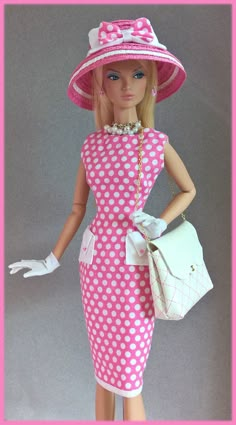 a barbie doll wearing a pink and white polka dot dress with matching hat and purse