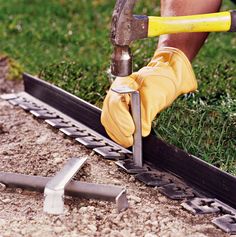 a man working with tools on the ground