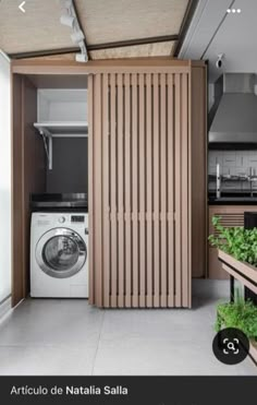 a washer and dryer in a room with wooden slats on the walls