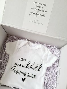 the first grandchild coming soon gift box is open and it's in its packaging