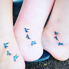 two people with blue birds on their feet