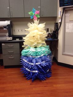 a stack of plastic objects sitting on top of a hard wood floor in an office